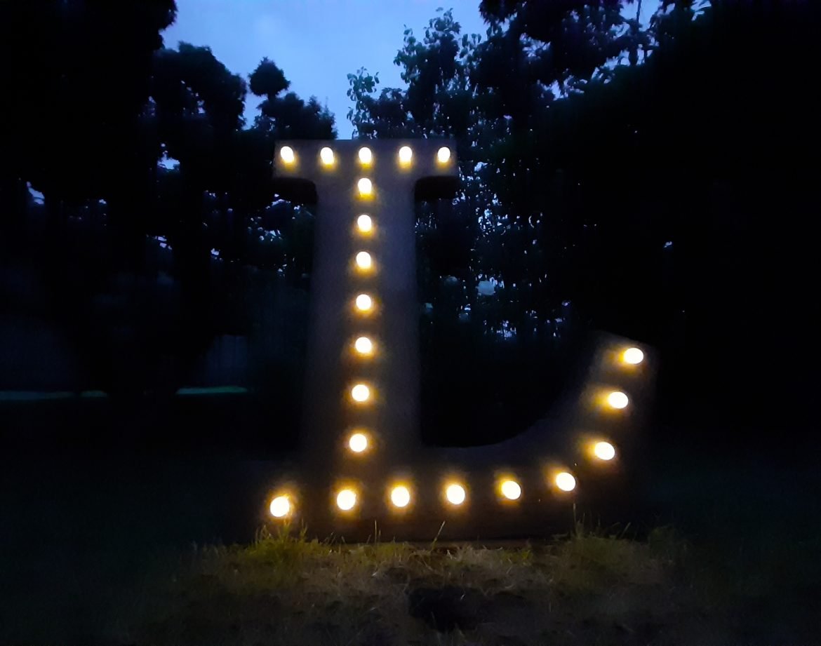 Lettera iniziale “L” luminosa in stile industriale